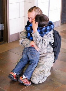 Mom hugging son.