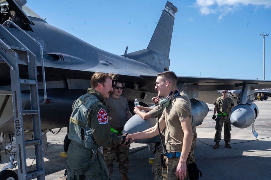 U.S. Air Force Senior Airman Joseph Lynch (right), crew chief, 140th Maintenance Group, Colorado Air National Guard greets U.S. Air Force Lt. Col. Daniel “Tracer” Way, pilot, 120th Fighter Squadron, 140th Wing, Colorado Air National Guard after Way lands at Tyndall Air Force Base, Florida, for Checkered Flag Oct. 25, 2023.