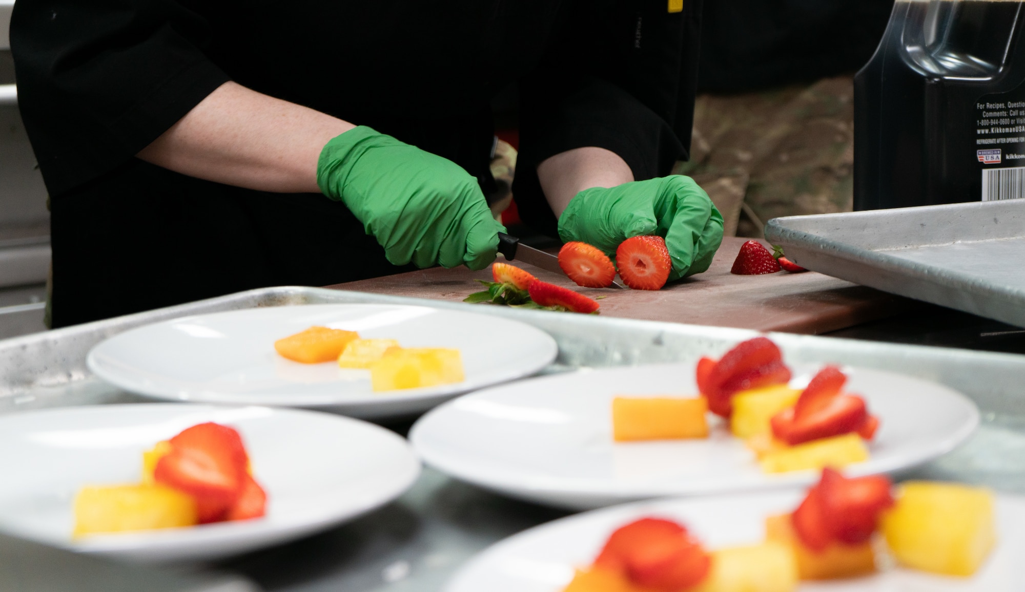 A 354th Force Support Squadron Airman slices strawberries during a cooking competition at the Wolves Den Warrior Restaurant on Fort Wainwright, Alaska, March 27, 2025.