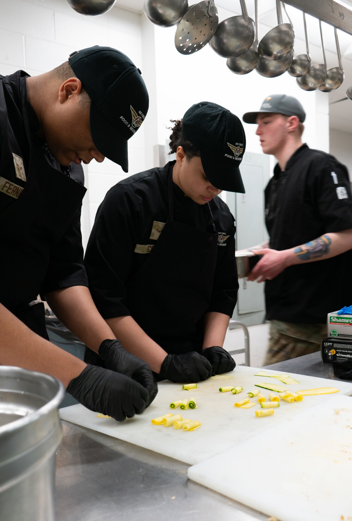 Two 354th Force Support Squadron Airmen prepare squash during the cooking competition at the Wolves Den Warrior Restaurant on Fort Wainwright, Alaska, March 27, 2025.
