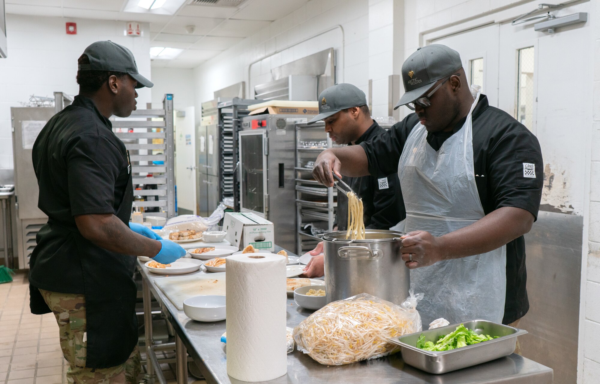 U.S. Army 1st Infantry Brigade Combat Team, 11th Airborne Division Soldiers prepare a 3-course meal for the judges during the cooking competition at the Wolves Den Warrior Restaurant on Fort Wainwright, Alaska, March 27, 2025.