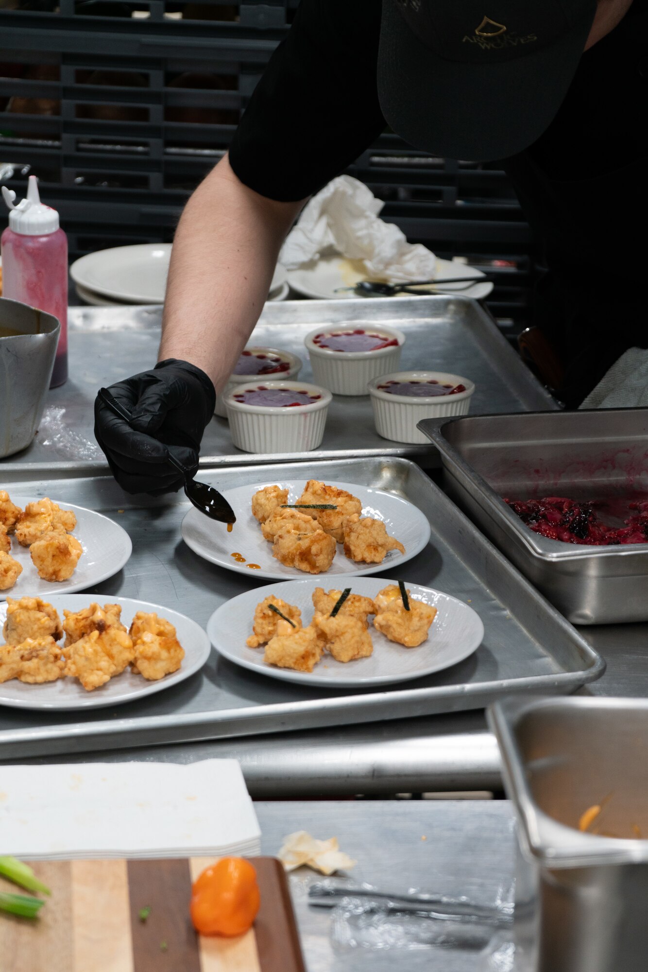 A 1st Infantry Brigade Combat Team, 11th Airborne Division Soldier plates an appetizer during a cooking competition at the Wolves Den Warrior Restaurant on Fort Wainwright, Alaska, March 27, 2025.