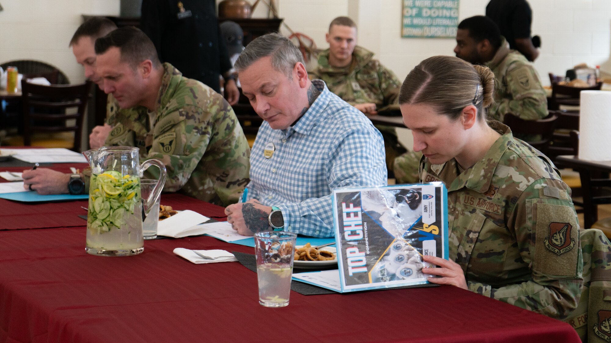 Leaders from the 354th Force Support Squadron, 25th Brigade Support Battalion and 1st Infantry Brigade Combat Team, 11th Airborne Division judge meals prepared by U.S. Air Force Airmen and U.S. Army Soldiers during a cooking competition at the Wolves Den Warrior Restaurant on Fort Wainwright, Alaska, March 27, 2025.