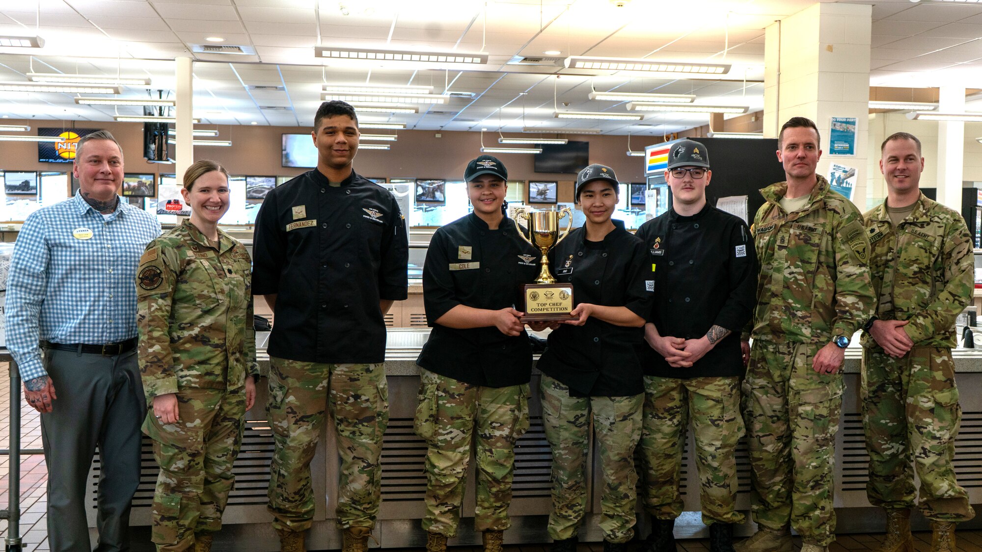 U.S. Air Force Airmen and U.S. Army Soldiers pose for a photo at the Wolves Den Warrior Restaurant on Fort Wainwright, Alaska, March 27, 2025.