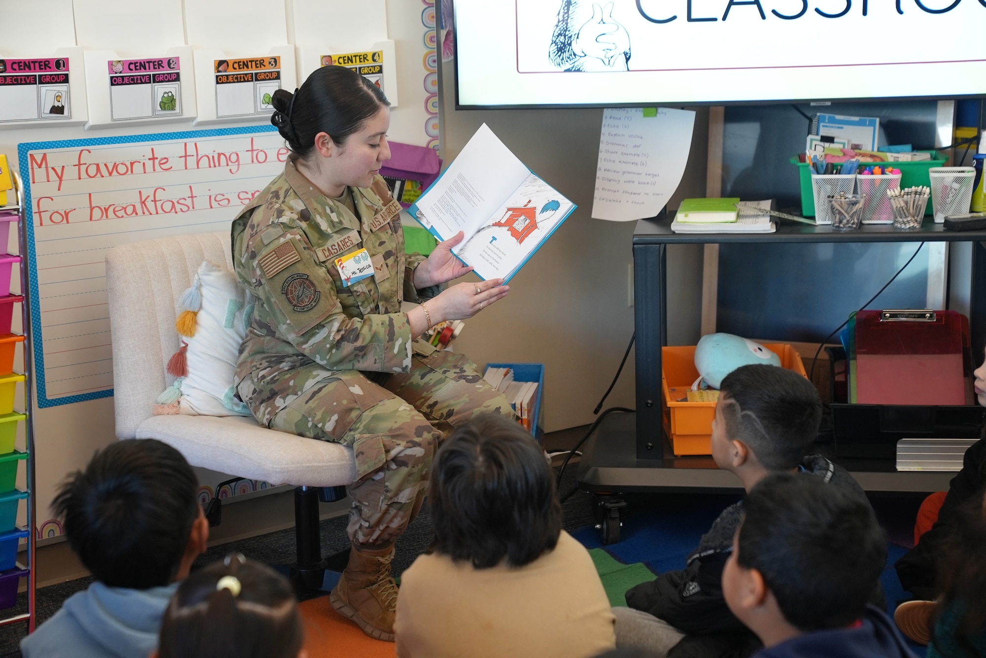 Airmen reading to students in the classroom.