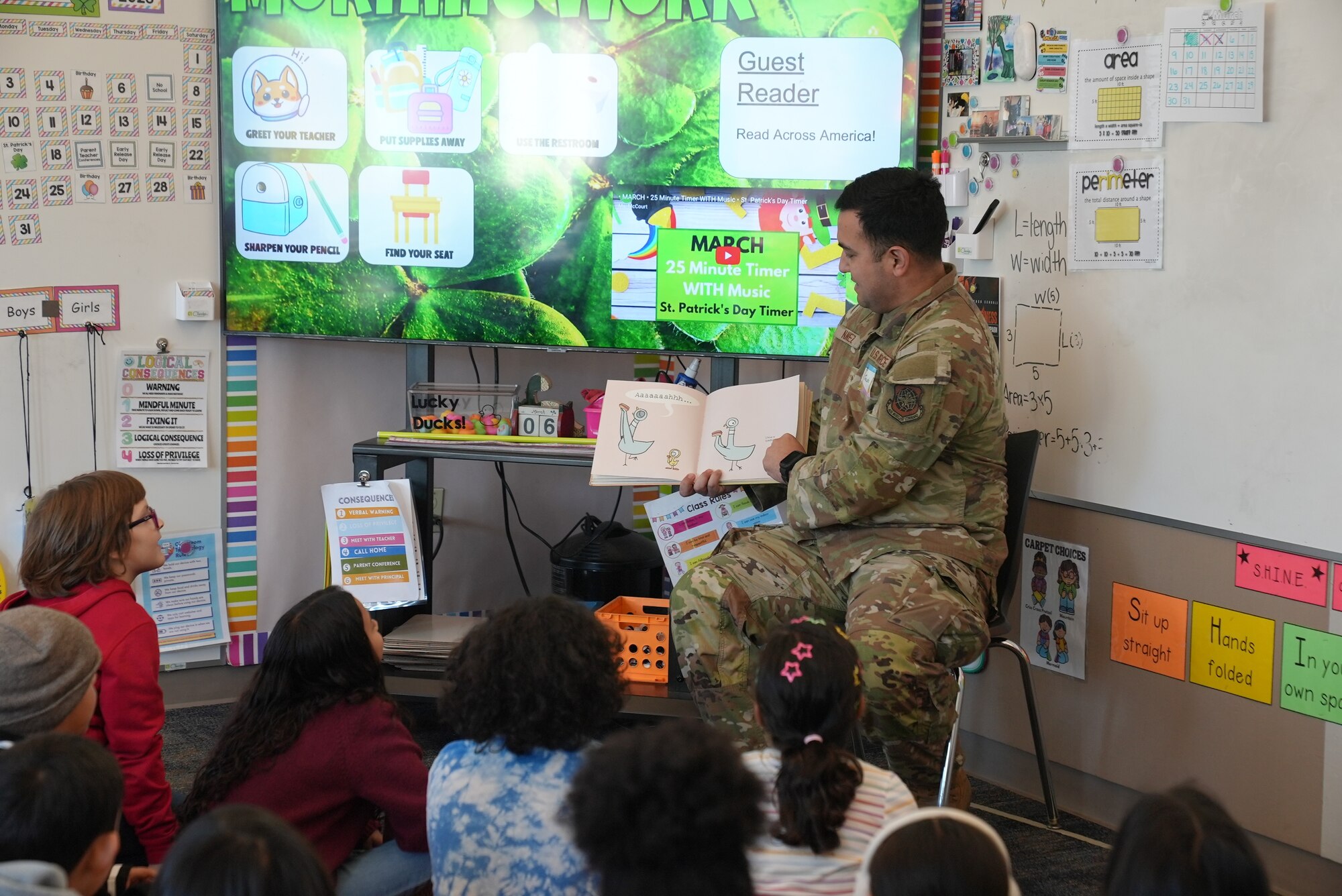 Airmen reading to students in the classroom.