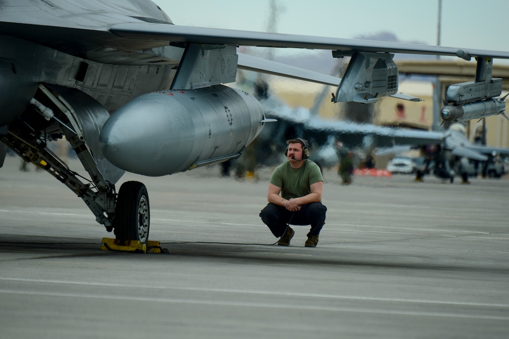 U.S. Air Force Senior Airman Alex Castellano, aircraft maintenance crew chief, 140th Wing, Colorado Air National Guard, monitors flight controls and wing flapper-on checks before the pilot launches at Red Flag from Nellis Air Force Base, Las Vegas, Nevada March 11, 2025.