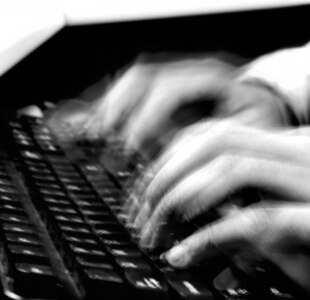 A combat coder writes computer code April 16, 2010, in the Combined Air and Space Operations Center. (U.S. Air Force photo illustration/Senior Airman Dillon White/released)