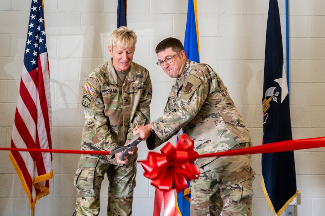 U.S. Army Brig. Gen. Laura L. Clellan, The adjutant general of the Colorado National Guard, cuts a ribbon with U.S. Air Force Lt. Col. Andy Gold, commander of the 138th Electronic Warfare Squadron on Peterson Space Force Base, Colorado Springs, Colo., August 5, 2023.