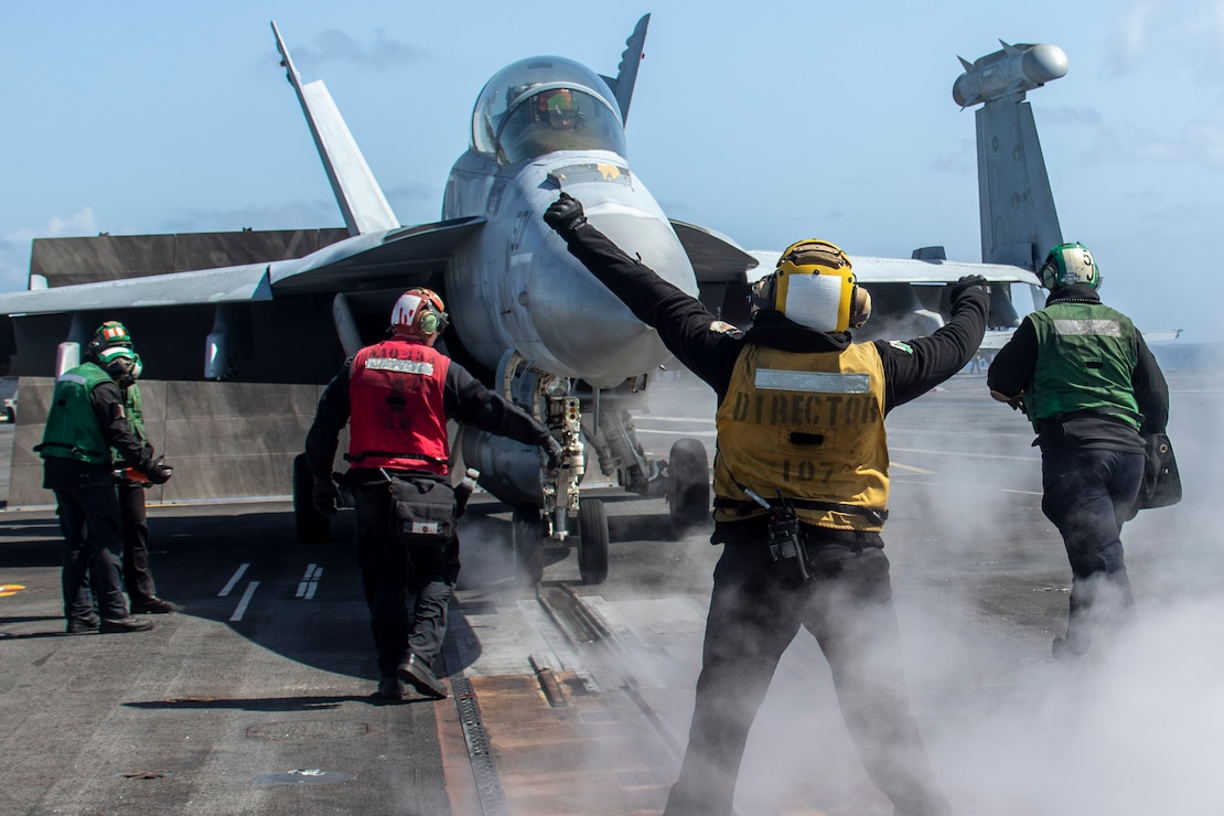 Sailors prepare to launch an EA-18G Growler, attached to Electronic Attack Squadron (VAQ) 133, from the flight deck of the Nimitz-class aircraft carrier USS Abraham Lincoln (CVN 72).