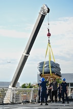 Crewmembers from Coast Guard Cutter James offload bales of interdicted narcotics in Port Everglades, April 9, 2025. James’ crew offloaded more than 44,550 pounds of cocaine and 3,880 pounds of marijuana valued at approximately $509.9 million intercepted in the international waters of the Eastern Pacific Ocean. (Coast Guard photo by Petty Officer 3rd Class Jessica Walker)