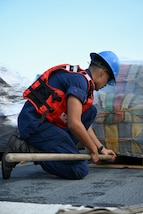 A crewmember from Coast Guard Cutter James prepares to offload a pallet of illegal narcotics in Port Everglades, April 9, 2025. James’ crew offloaded more than 44,550 pounds of cocaine and 3,880 pounds of marijuana valued at approximately $509.9 million intercepted in the international waters of the Eastern Pacific Ocean. (Coast Guard photo by Petty Officer 3rd Class Jessica Walker)