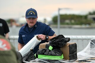 A crew member from Coast Guard Cutter James wraps a pallet of illegal narcotics in Port Everglades, April 9, 2025. James’ crew offloaded more than 44,550 pounds of cocaine and 3,880 pounds of marijuana valued at approximately $509.9 million intercepted in the international waters of the Eastern Pacific Ocean. (Coast Guard photo by Petty Officer 3rd Class Jessica Walker)
