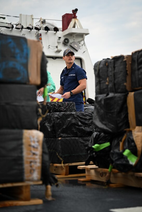 A crew member from Coast Guard Cutter James assists in offloading illegal narcotics in Port Everglades, April 9, 2025. James’ crew offloaded more than 44,550 pounds of cocaine and 3,880 pounds of marijuana valued at approximately $509.9 million intercepted in the international waters of the Eastern Pacific Ocean. (Coast Guard photo by Petty Officer 3rd Class Jessica Walker)