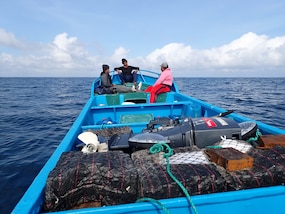 Suspected drug smugglers sit at the front of their vessel in the Eastern Pacific Ocean, Jan 6. 2025. The crew of U.S. Coast Guard Cutter James offloaded more than 44,550 pounds of cocaine and 3,880 pounds of marijuana valued at approximately $509.9 million in Port Everglades, April 9, 2025. (U.S. Coast Guard photo)
