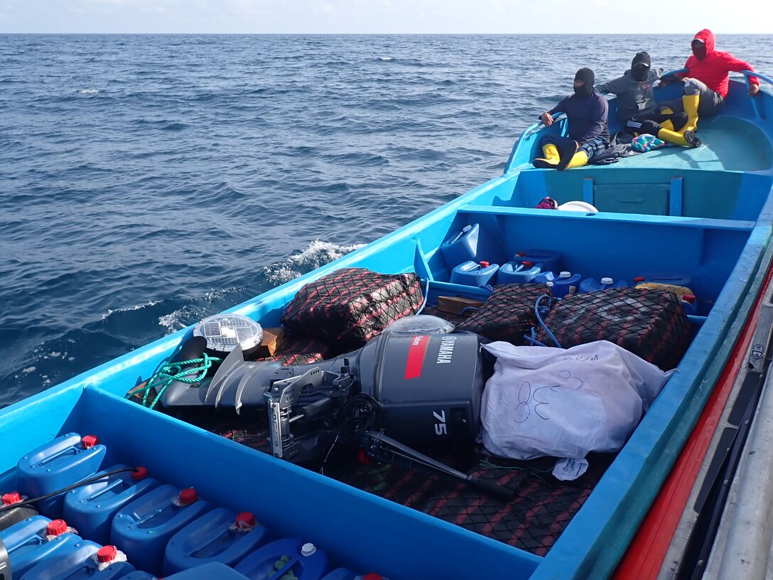 Suspected drug smugglers sit at the front of their vessel in the Eastern Pacific Ocean, Jan. 6, 2025. The crew of U.S. Coast Guard Cutter James offloaded more than 44,550 pounds of cocaine and 3,880 pounds of marijuana valued at approximately $509.9 million in Port Everglades, April 9, 2025. (U.S. Coast Guard photo)