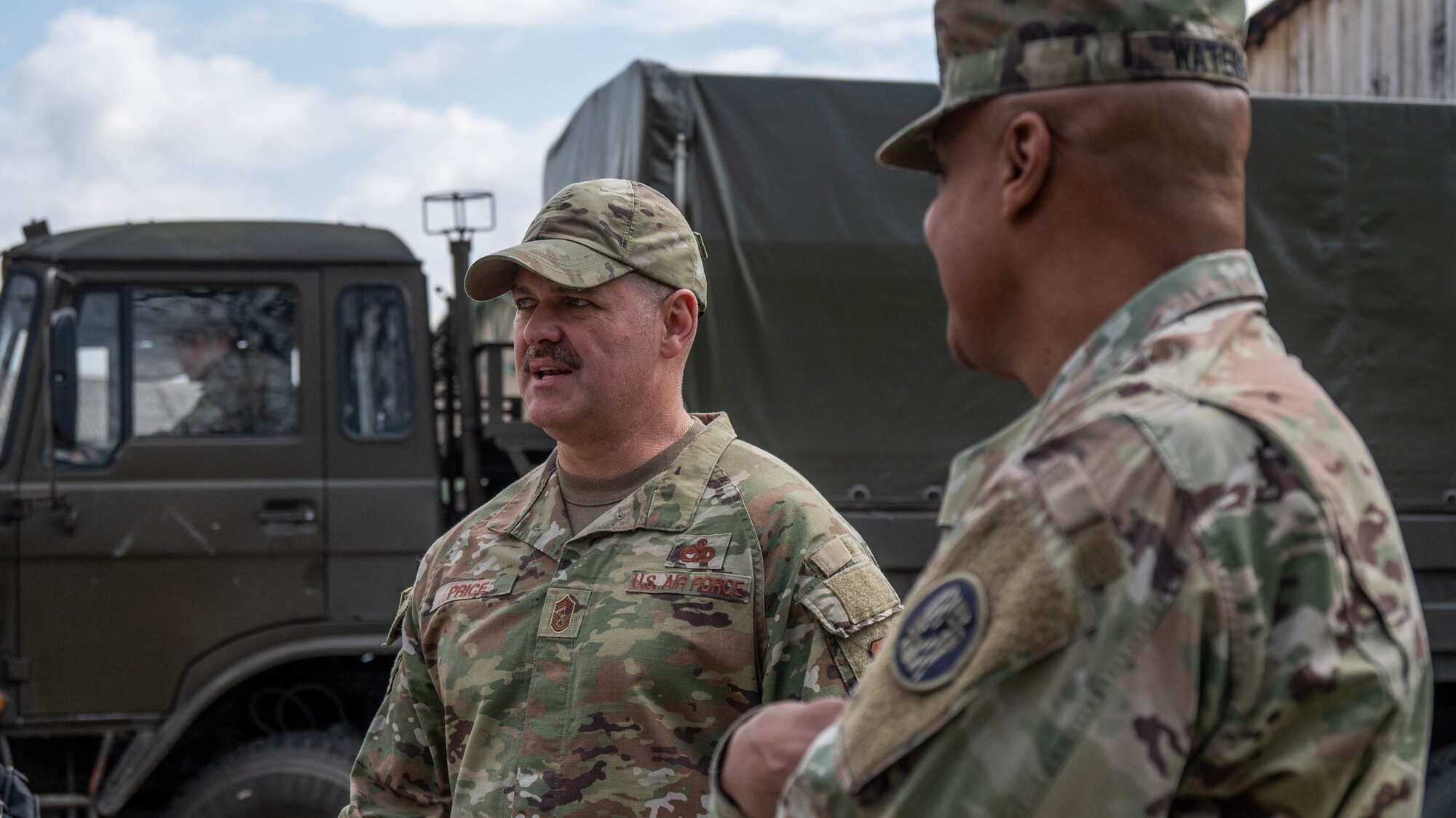 Maryland Air National Guard Command Chief Master Sgt. Shane Price, Maryland Air National Guard’s state command chief (left) and Maryland Army National Guard Col. Louis Waters, deputy chief of staff for logistics (G-4) (right), observe convoy operations at the 7th Muslim Brigade barracks in Zenica, Bosnia and Herzegovina, April 4, 2025.