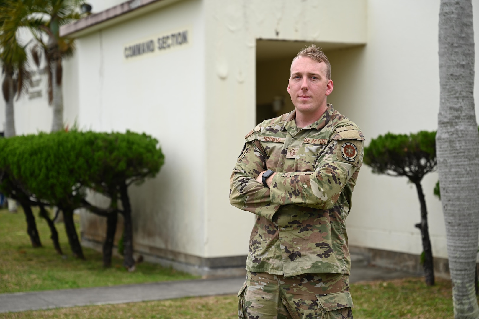 Photo of U.S. Air National Guard Senior Master Sgt. Bryan Sdankus, assigned to the 158th Fighter Wing, standing in front of the Command Section building on Kadena Air Base, Okinawa Japan, March 26, 2025.