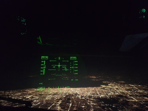 A heads-up display glows inside the cockpit of a U.S. Air Force C-17 Globemaster III aircraft assigned to the 6th Airlift Squadron during a nighttime approach over an undisclosed location, no date. Operating under the cover of darkness, 6th AS aircrews conducted global missions that demand precision, agility, and 24/7 readiness—core tenets of Air Mobility Command’s Rapid Global Mobility mission. (U.S. Air Force courtesy photo)