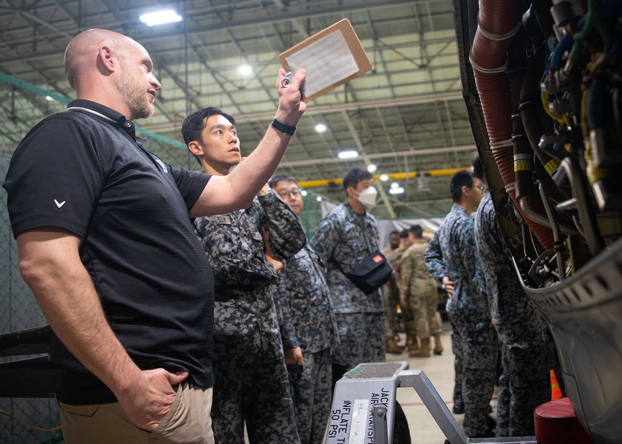 People discuss aircraft components.