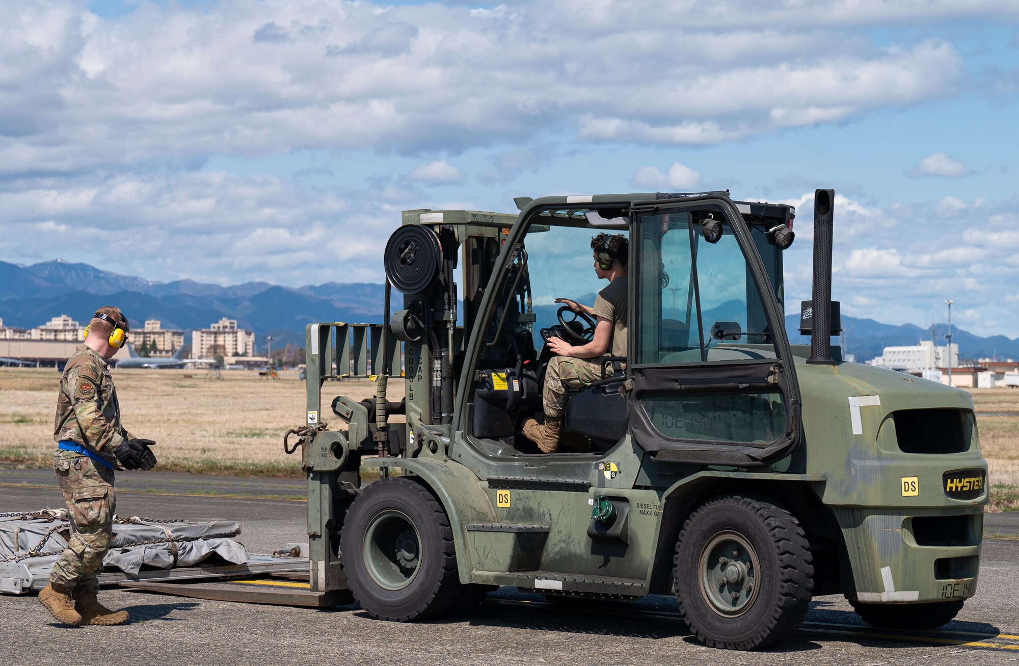 Man directs forklift driver.