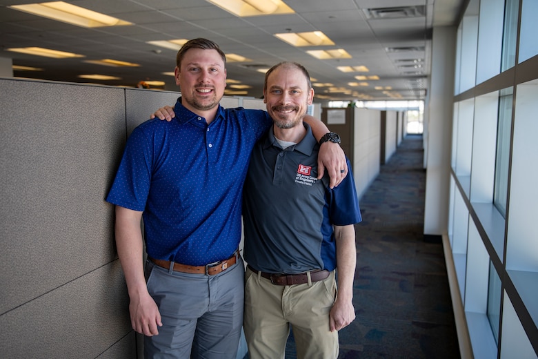 Dustin Davis (left), deputy chief of construction, poses with his arm around his older brother, Jeremy Davis (right), an interdisciplinary geologist, April 8, 2025, at the Edward Zorinsky Federal Building in Omaha, Nebraska.