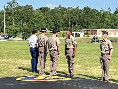 Spc. Uriel Rosario, a cavalry scout assigned to "Crazy" Troop, 1st Squadron, 94th Cavalry Regiment, is presented with the Excellence in Armor award during his one-station unit training graduation at Fort Moore, GA, June 2024.