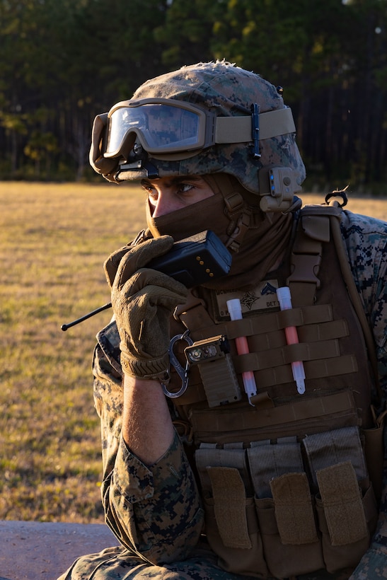 U.S. Marine Corps Cpl. Noah J. McGhee, landing support team leader with Combat Logistics Battalion 25, 4th Marine Logistics Group, speaks into a radio at Camp Lejeune, North Carolina, Mar. 27, 2025. Landing support specialists and pilots conducted HST to familiarize themselves with insertions and extractions of heavy loads to increase their proficiency in combat scenarios. (U.S. Marine Corps photo by Cpl. Salvador Flores Perez)