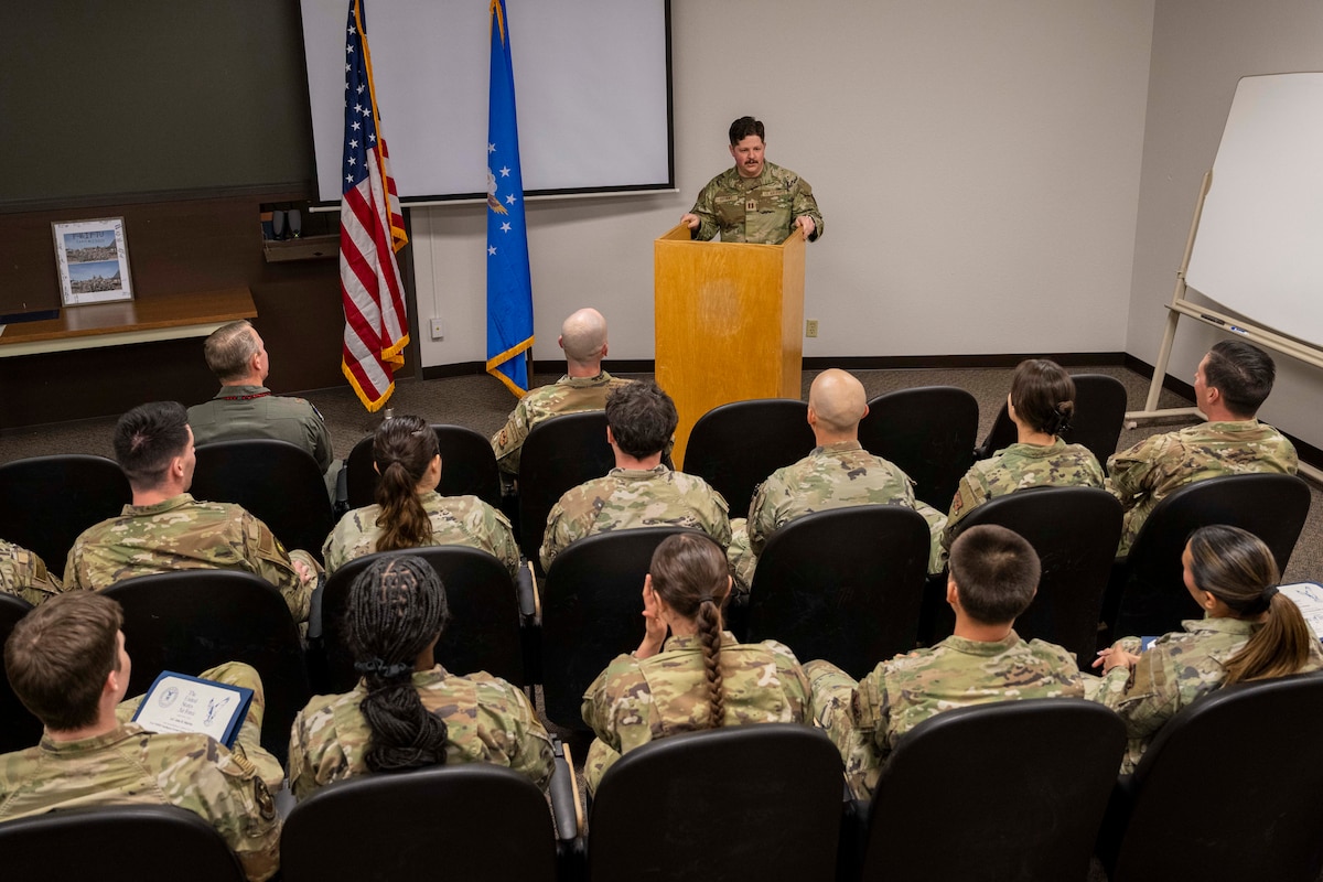U.S. Air Force Capt. Bailey Bryant, 54th Operations Support Squadron F-16 Fighting Falcon intelligence formal training unit instructor cadre, gives a speech during the first 54th OSS F-16 IFTU graduation at Holloman Air Force Base, New Mexico, April 3, 2025.