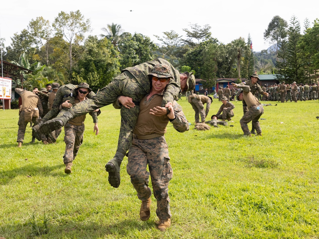 U.S. Marines and Sailors with Marine Rotational Force — Darwin 25.3 and Armed Forces of the Philippines service members practice fireman carries during tactical field care training as part of Marine Exercise 2025 near Cotabato City, Mindanao, Philippines, April 1, 2025.