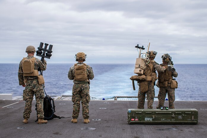U.S. Marines assigned to Battalion Landing Team 1/5, 15th Marine Expeditionary Unit, and Marine Medium Tiltrotor Squadron (VMM) 165 (Reinforced), 15th MEU, scan for simulated threats from the amphibious assault ship USS Boxer (LHD 4) with a NightFighter S portable counter-unmanned aerial vehicle system, a MODI II system, and an FIM-92 Stinger during a counter-unmanned aircraft system drill in the Pacific Ocean July 20, 2024. Elements of the 15th MEU are currently embarked aboard the Boxer Amphibious Ready Group conducting routine operations in U.S. 3rd Fleet. (U.S. Marine Corps photo by Cpl. Amelia Kang)
