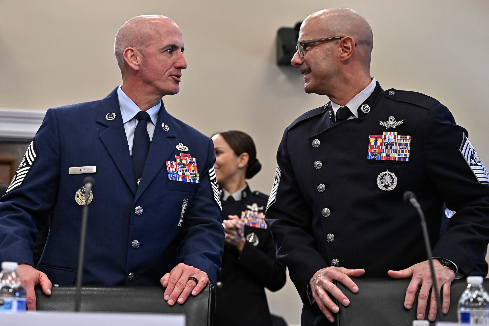 Chief Master Sgt. of the Air Force David Flosi speaks with Chief Master Sgt. of the Space Force John Bentivegna before testifying to the House Appropriations Committee