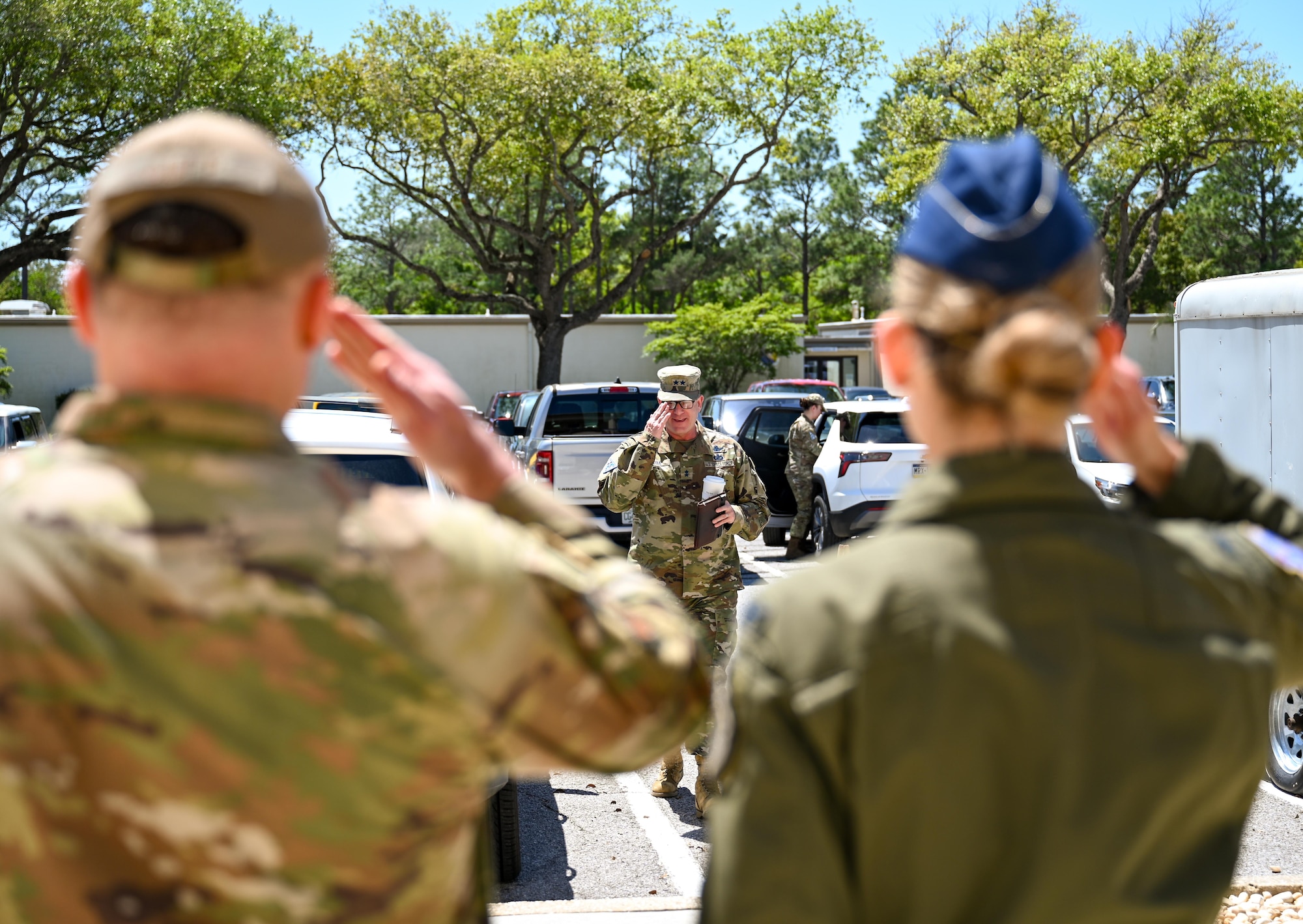 U.S. Air Force Chief Master Sgt. Will Cupp, 350th Spectrum Warfare Wing command chief, left, and U.S. Air Force Col. Candice Sperry, 350th Spectrum Warfare Group commander, right, salute U.S. Space Force Maj. Gen. Timothy Sejba, Space Training and Readiness Command commander, middle, at the start of his visit to the 350th Spectrum Warfare Wing at Eglin Air Force Base, Florida, April 8, 2025. Sejba visited the 350 SWW as part of a larger visit to multiple Florida Panhandle units. (U.S. Air Force photo by Capt. Benjamin Aronson)
