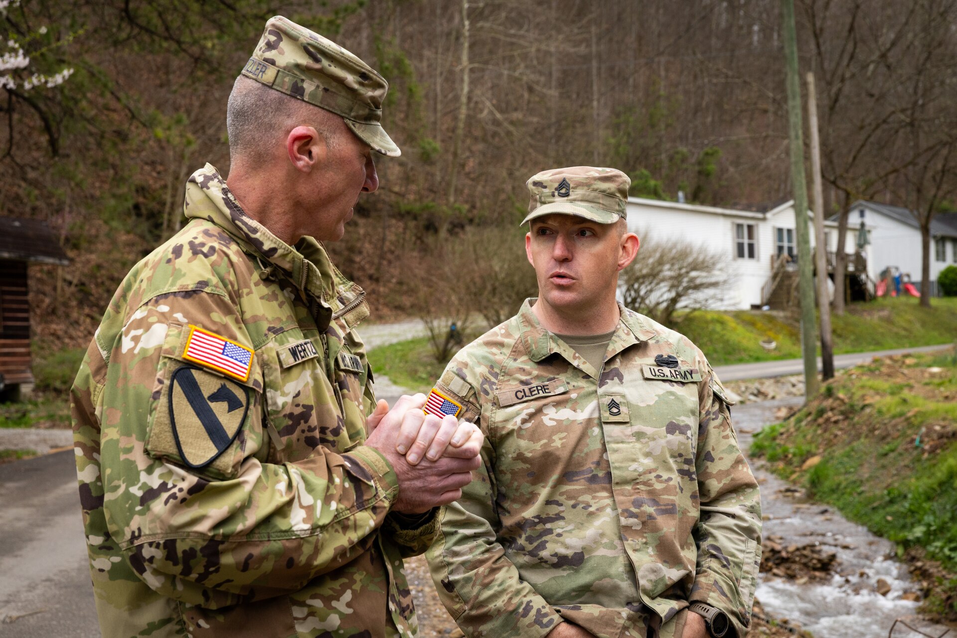 U.S. Army Brig. Gen. Brian Wertzler and Sgt. 1st Class Ron Clere discusses repairs to critically damaged county roads in Hindman, Ky. on April 1, 2025. Clere and members of Detachment 1, 149th Vertical Construction Company, 149th Maneuver Enhancement Brigade have been working for over a month to help counties repair critical roads since flooding in February. (U.S. Army National Guard photo by Andy Dickson)