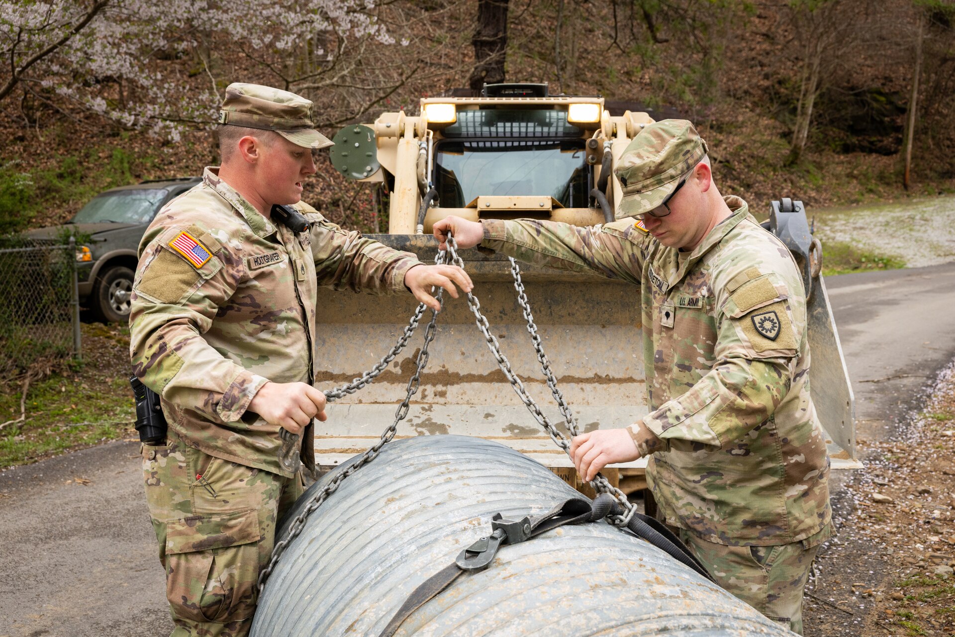 U.S. Army Staff Sgt. Micheal Holtgraver, and Spc. Devon Middleton ties up a culvert pipe on a county road in Hindman, Ky. on April 1, 2025. Holtgraver, Middleton, and members of Detachment 1, 149th Vertical Construction Company, 149th Maneuver Enhancement Brigade have been working for over a month to help counties repair critical roads since flooding in February. (U.S. Army National Guard photo by Andy Dickson)
