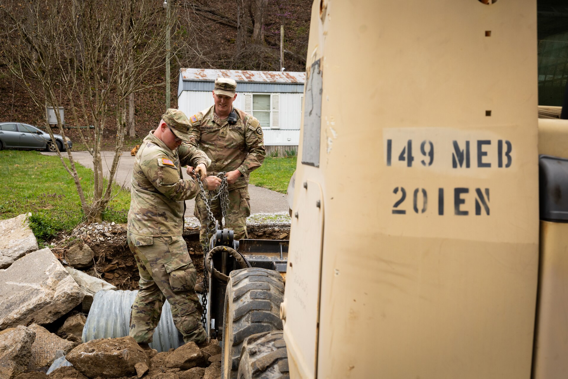 U.S. Army Staff Sgt. Micheal Holtgraver, and Spc. Devon Middleton ties up a culvert pipe on a county road in Hindman, Ky. on April 1, 2025. Holtgraver, Middleton, and members of Detachment 1, 149th Vertical Construction Company, 149th Maneuver Enhancement Brigade have been working for over a month to help counties repair critical roads since flooding in February. (U.S. Army National Guard photo by Andy Dickson)