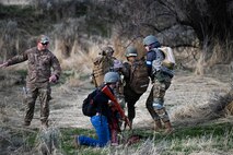 Cadets carry a simulated wounded midshipman during a training exercise
