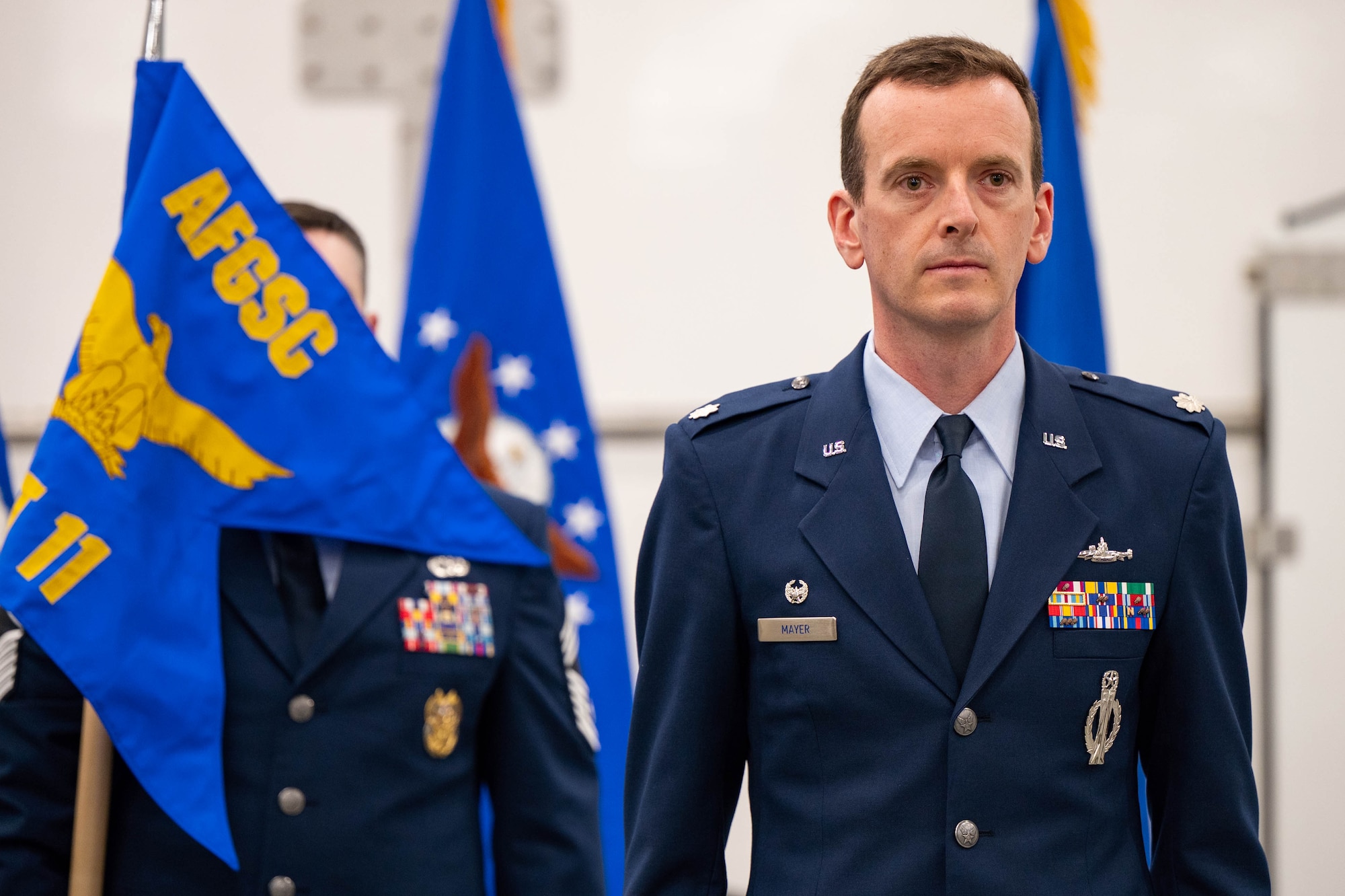 Men in uniform conduct a ceremony.