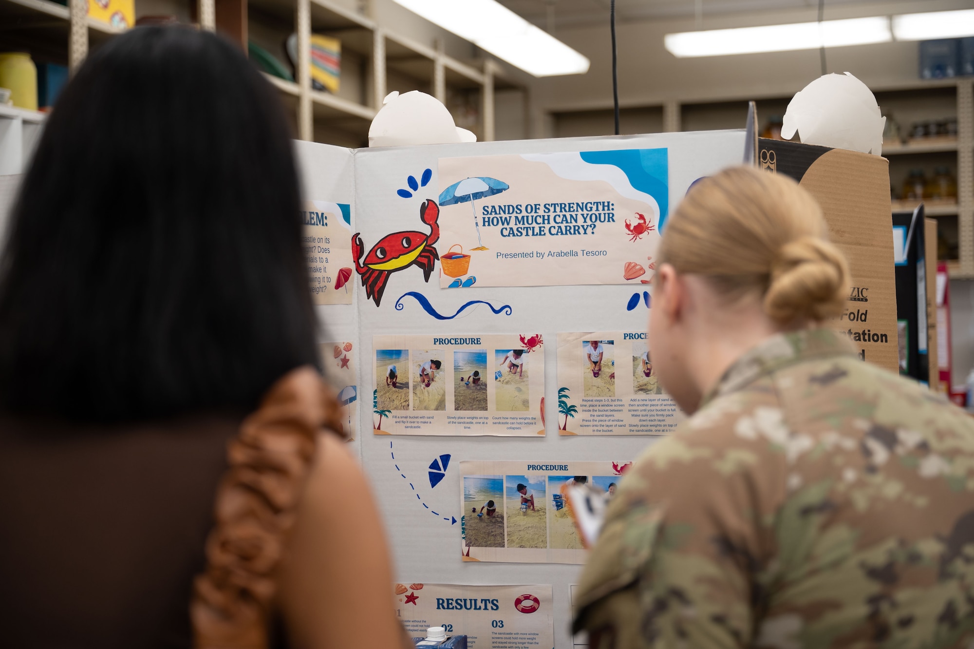 36th Medical Group, evaluate a science project during the Guam Island Wide Science Fair at the University of Guam, April 5, 2025. The purpose of the fair was to stimulate an interest in science in the Guam youth and community. (U.S. Air Force photo by Senior Airman Audree Campbell)