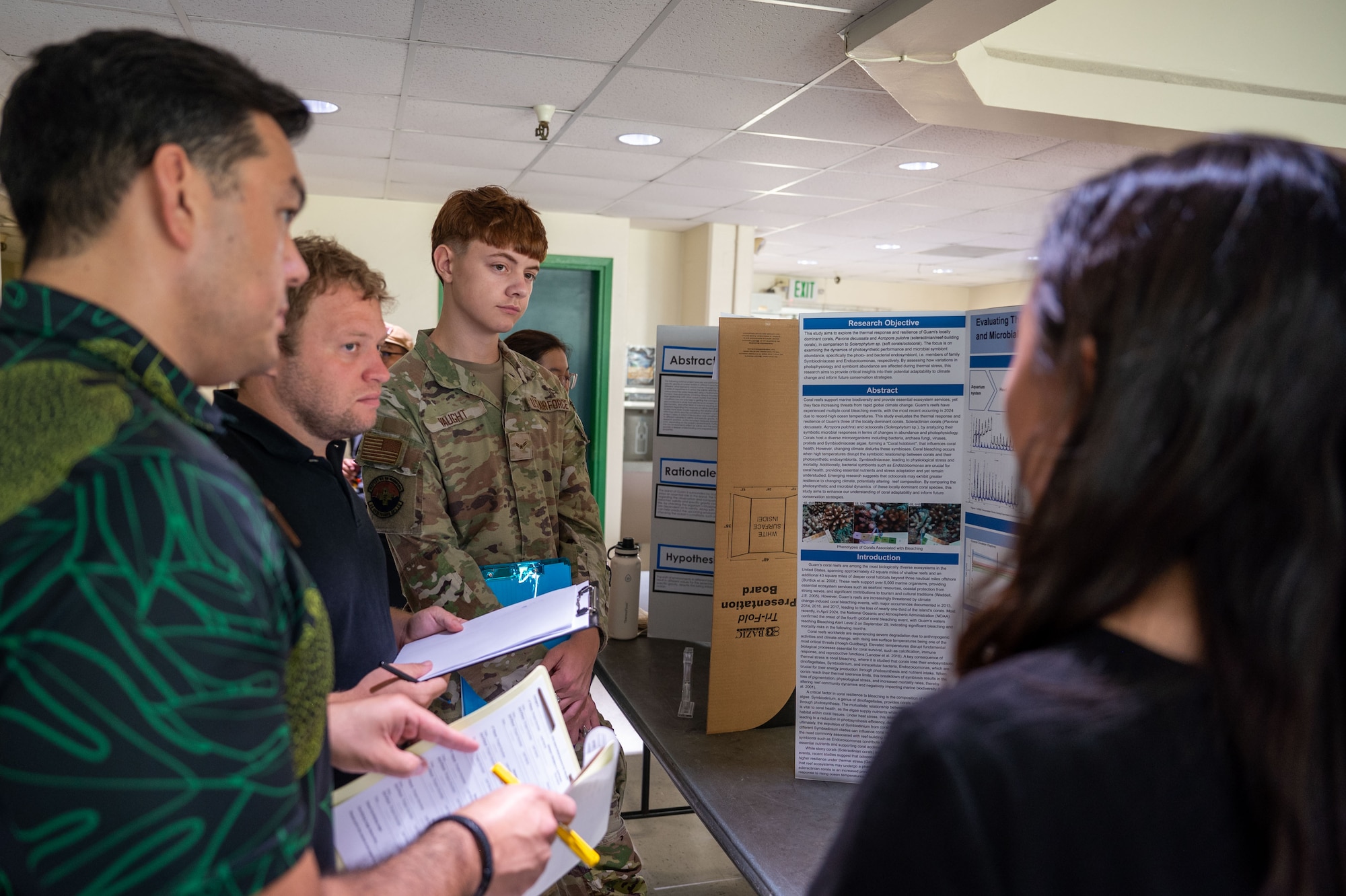 36th Medical Group, evaluate a science project during the Guam Island Wide Science Fair at the University of Guam, April 5, 2025. The purpose of the fair was to stimulate an interest in science in the Guam youth and community. (U.S. Air Force photo by Senior Airman Audree Campbell)