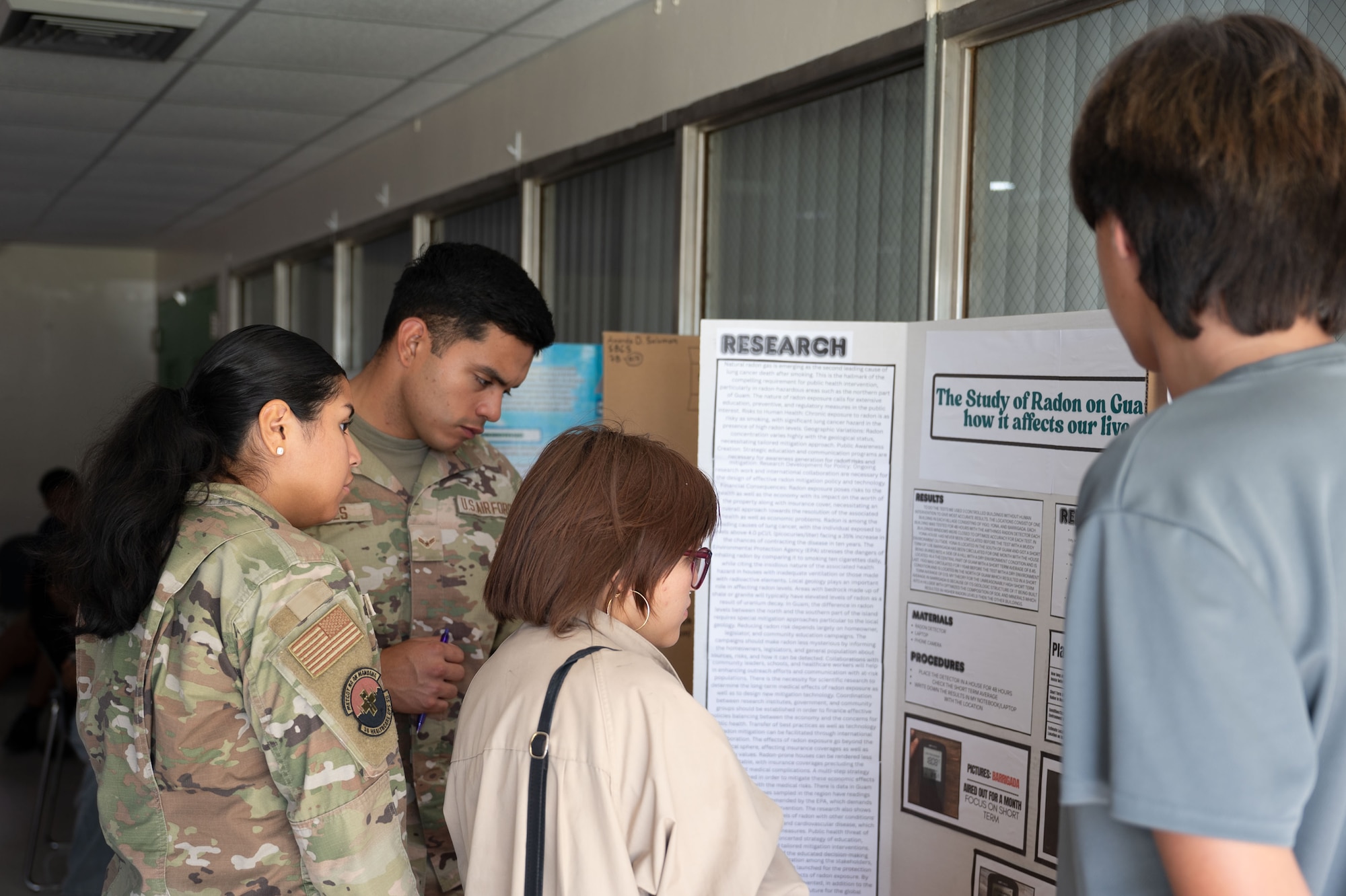 36th Medical Group, evaluate a science project during the Guam Island Wide Science Fair at the University of Guam, April 5, 2025. The purpose of the fair was to stimulate an interest in science in the Guam youth and community. (U.S. Air Force photo by Senior Airman Audree Campbell)