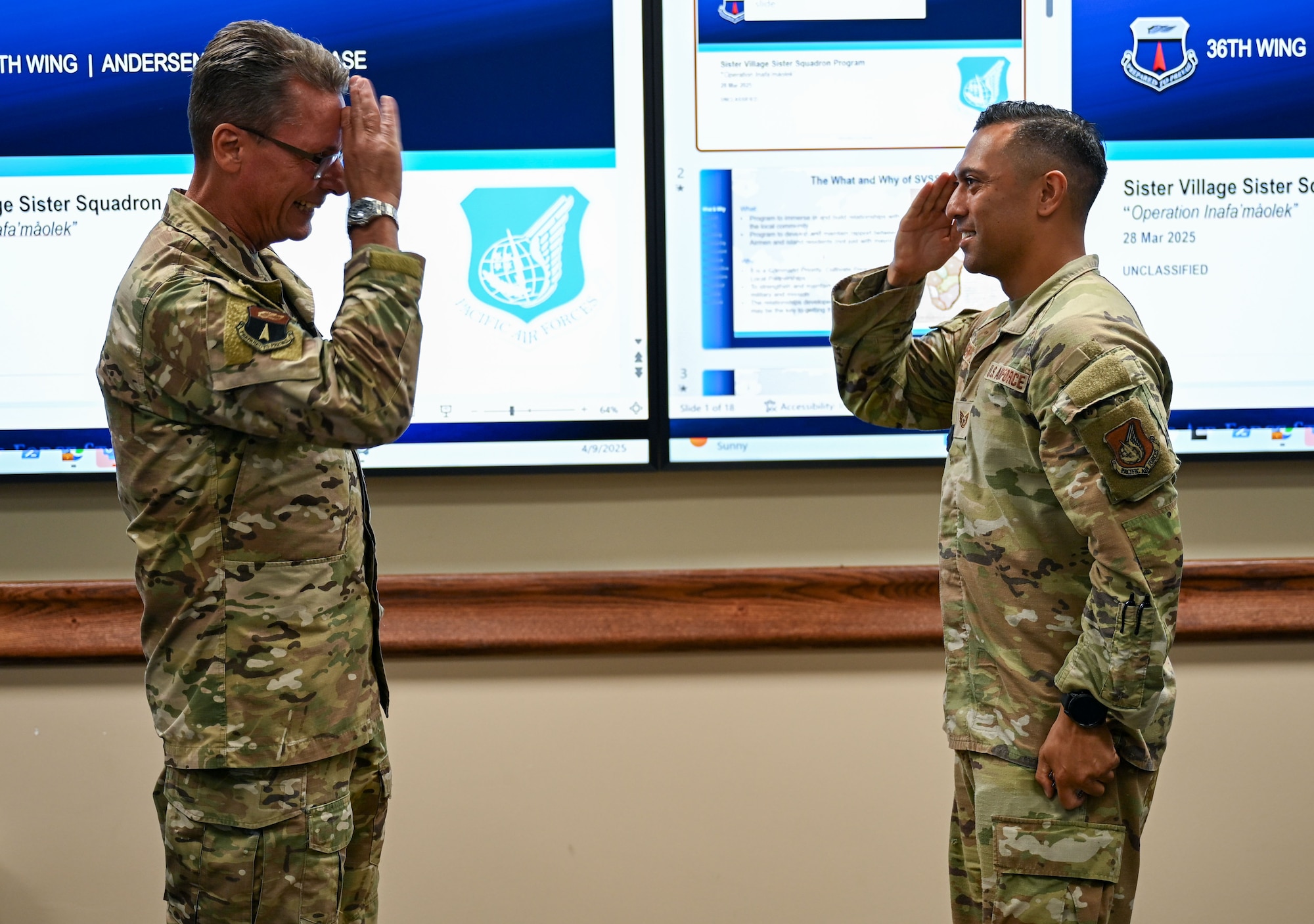 Sister Village Sister Squadron representative U.S. Air Force Tech. Sgt. Andy Renteria, 36th Medical Group TRICARE Operations and Patient Administration flight chief, gets coined by Brig. Gen. Thomas Palenske, 36th Wing commander, at Andersen Air Force Base, Guam, April 8, 2025. Renteria and other SVSS Airmen were recognized for their dedication to fostering and upholding relationships with the Mayors and community of their respective villages in Guam to provide volunteer support, mentorship, environmental clean ups and more. (U.S. Air Force photo by Senior Airman Audree Campbell)