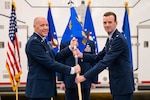 Men in uniform conduct a ceremony.