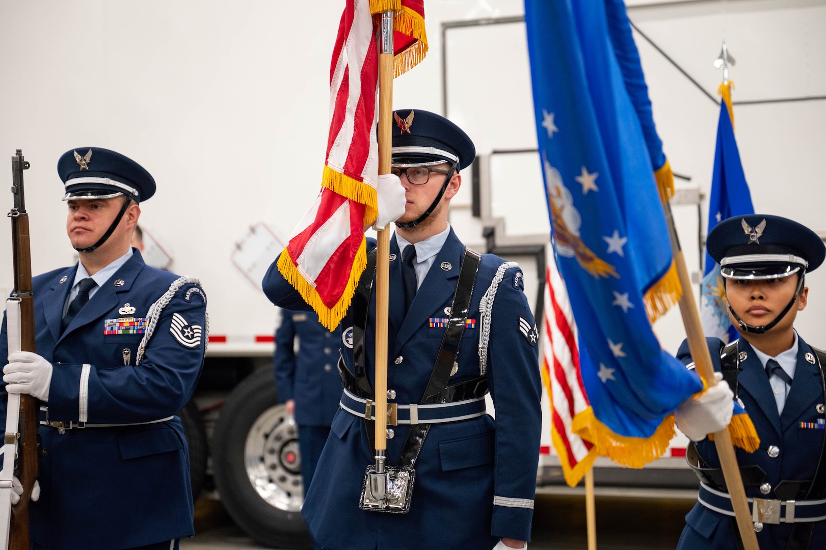 Men in uniform conduct a ceremony.