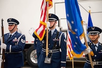 Men in uniform conduct a ceremony.