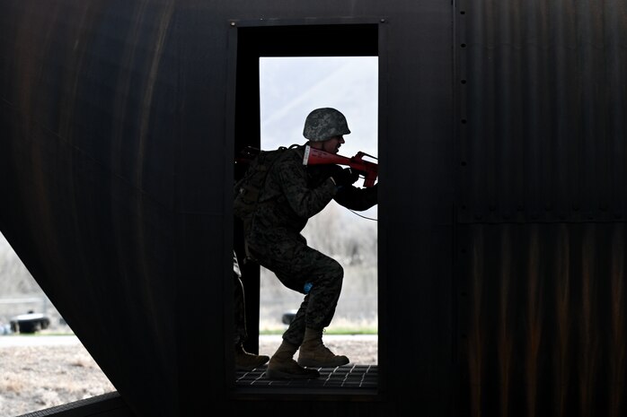 Silhouette of a ROTC student holding a weapon in a doorway