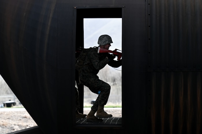 Silhouette of a ROTC student holding a weapon in a doorway