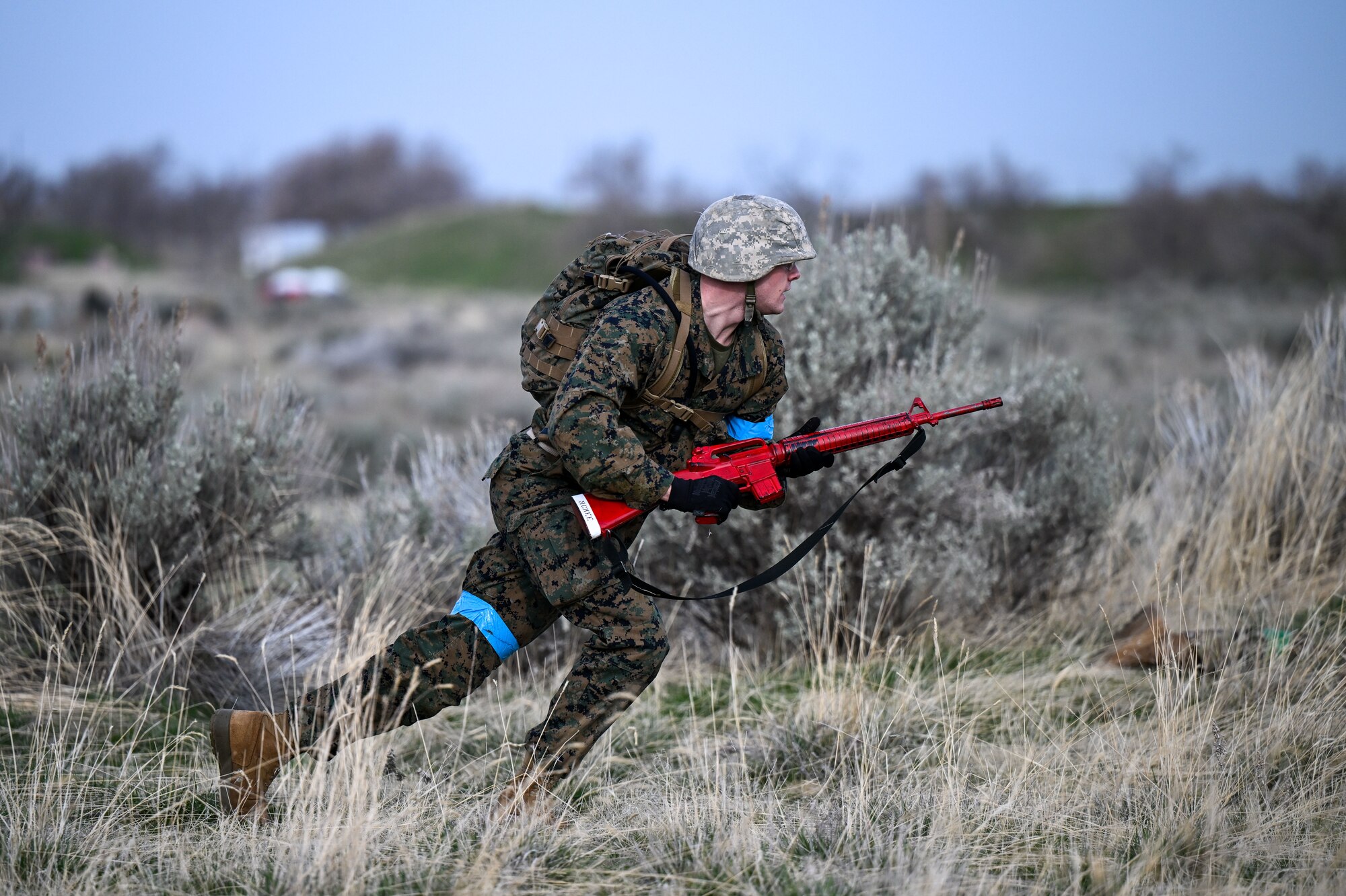 A ROTC student runs to take cover in a field