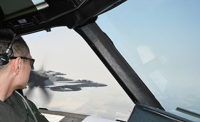 PHILIPPINE SEA (April 3, 2025) E/A-18G Growlers from the expeditionary Electronic Attack Squadron (VAQ) 131 are seen from the cockpit of a Japan Maritime Self-Defense Force (JMSDF) UP-3D aircraft during the Fujin bilateral training exercise, April 3, 2025. The planning and execution of the exercise came after the JMSDF Commander, Fleet Air Force (CFAF), and U.S. Navy's Commander, Task Force (CTF) 70, signed the Fujin memorandum of understanding to increase bilateral operations between the forces’ electronic attack squadrons in December 2024. (Courtesy photo)