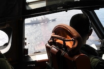 The Japan Maritime Self-Defense Force (JMSDF) Murasame-class destroyer JS Inazuma (DD-105) is seen from the cockpit of a JMSDF UP-3D aircraft during their Fujin bilateral training exercise with the U.S. Navy's expeditionary Electronic Attack Squadron (VAQ) 131.